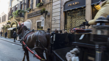 Rome, Italy - January 1, 2017: Carriage with horse carrying tourists on Via Condotti  in Rome, Italy, one of the most exclusives streets in Europe